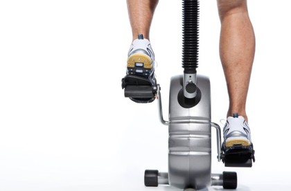 A man cycling on an exercise bike.