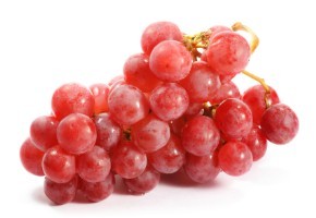 A bunch of red grapes on a white background.