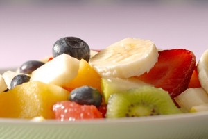 A close up shot of a bowl of fruit salad.