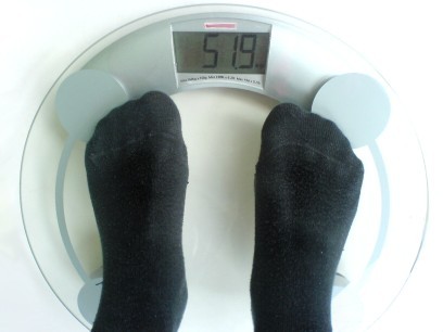 A person standing on some weighing scales.