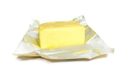 A block of butter on top of its foil wrapper.