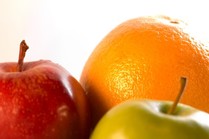A red apple, green apple and orange.