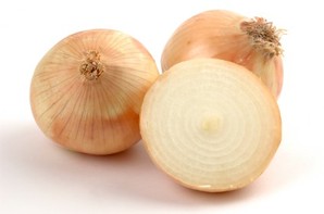 Two full onions and one onion chopped in half on a white background.