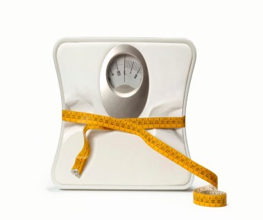 A set of weighing scales wrapped in a tape measure.
