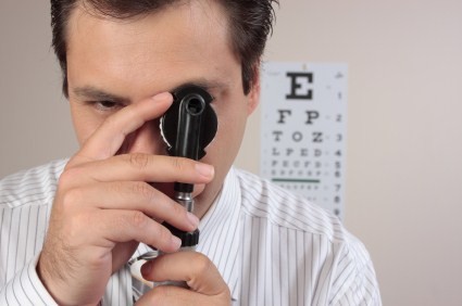 An opthamologist staring through 1 of his instruments.