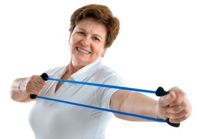 An elderly woman using a resistance band.