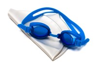 A pair of blue goggles on top of a white swim cap.