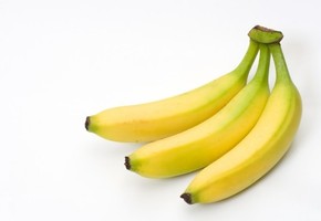 A bunch of bananas on a white background.