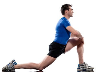 A man stretching his legs on a white background.