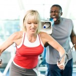 A girl working out while her personal trainer bellows instructions with a megaphone.