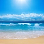 The sun shining on a beach.