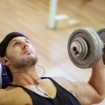 A man performing dumbbell chest presses.