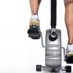 A man cycling on an exercise bike.
